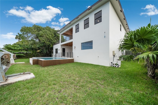 back of house with a lawn