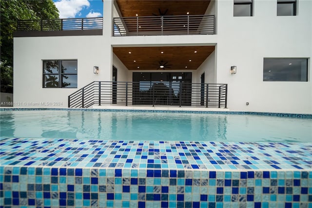 view of swimming pool with ceiling fan and a patio