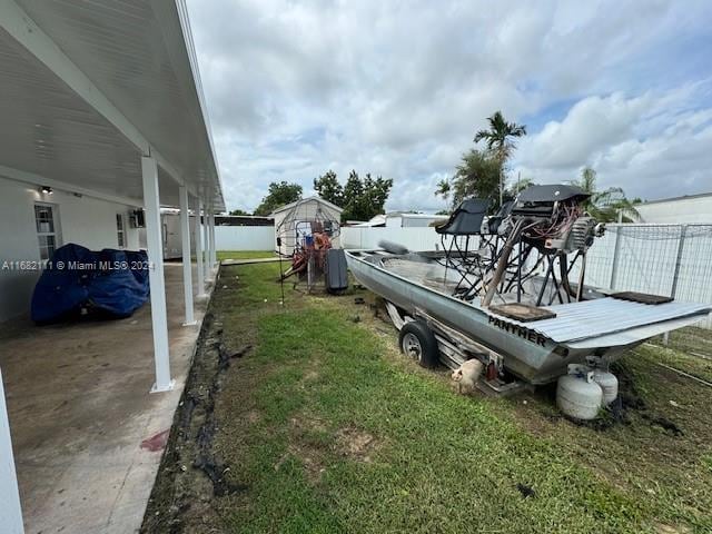 view of yard with a shed and a patio area