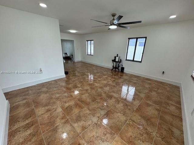 spare room with ceiling fan