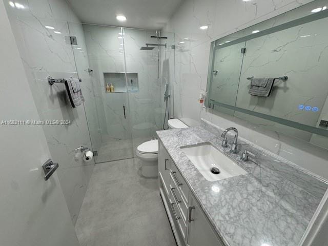 bathroom featuring vanity, toilet, and a shower with door