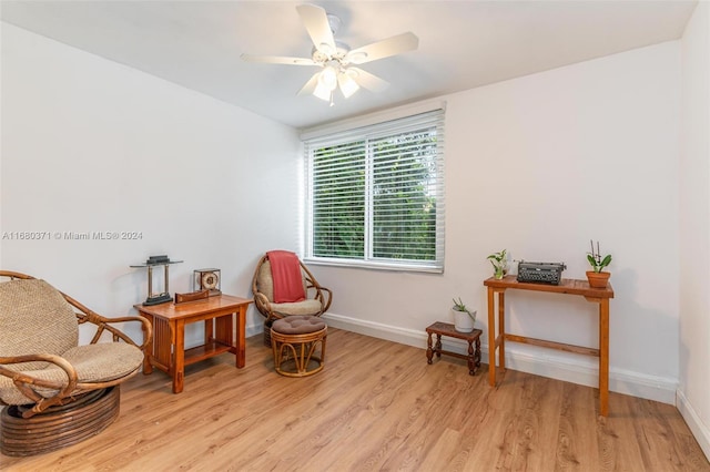 sitting room with light hardwood / wood-style floors and ceiling fan