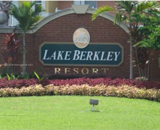 community / neighborhood sign with a lawn