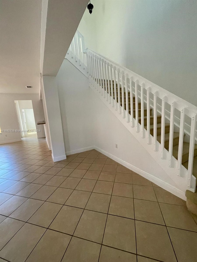 stairs featuring tile patterned floors