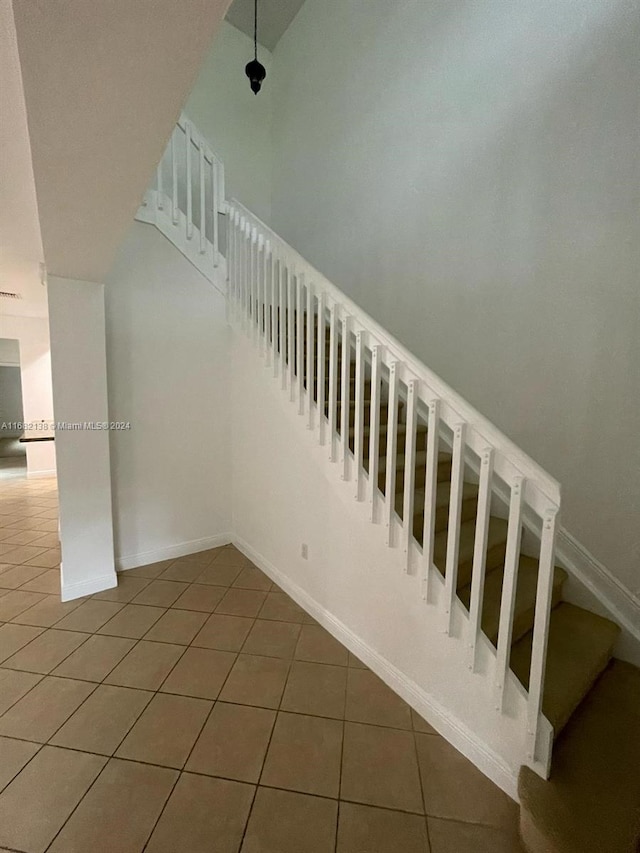 stairway featuring tile patterned flooring