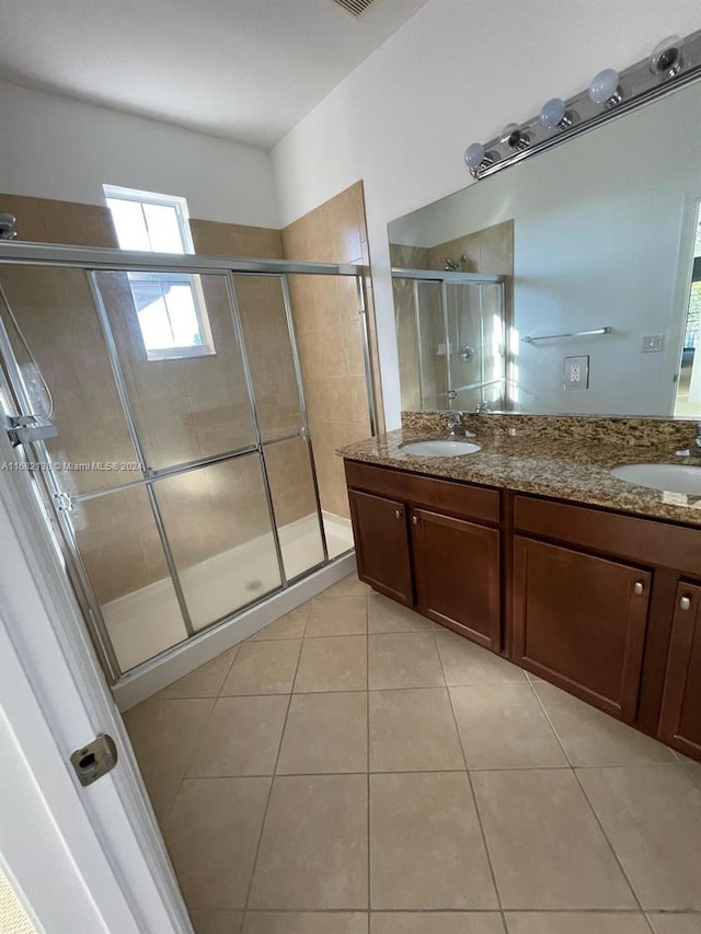 bathroom featuring vanity, tile patterned floors, and a shower with door