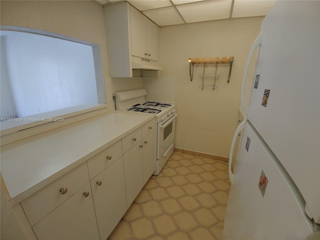 1305 W 53rd St Unit 410, Hialeah, FL 33012 - kitchen with white appliances, light countertops, under cabinet range hood, and white cabinetry
