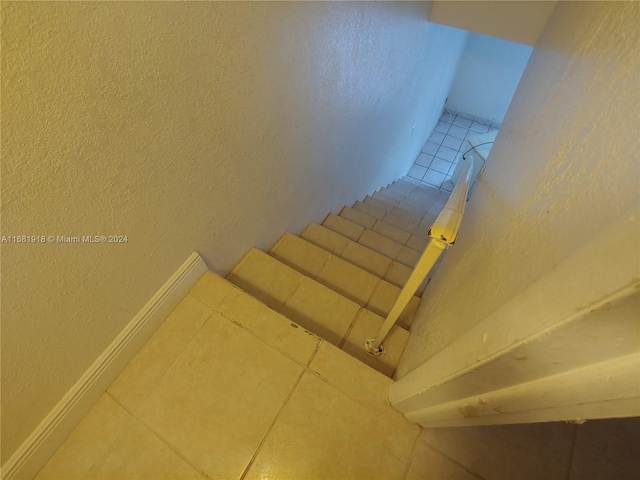 staircase featuring tile patterned floors