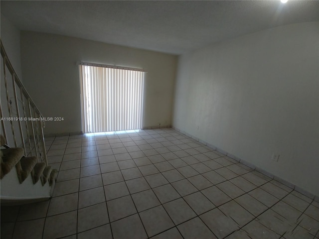1305 W 53rd St Unit 410, Hialeah, FL 33012 - empty room featuring stairs and light tile patterned flooring