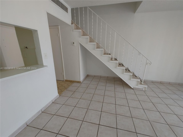 stairs with tile patterned floors