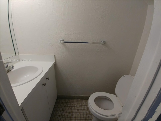 bathroom featuring vanity, toilet, and tile patterned floors