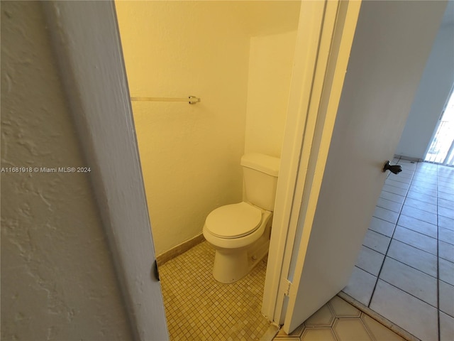 bathroom featuring toilet and tile patterned floors