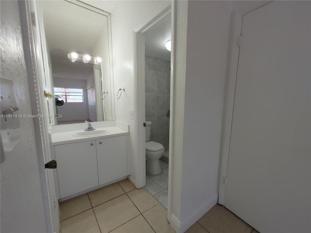 bathroom featuring vanity, toilet, and tile patterned flooring