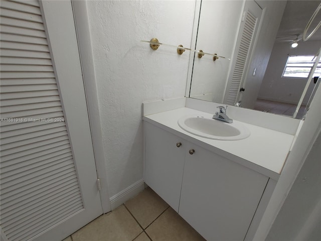 1305 W 53rd St Unit 410, Hialeah, FL 33012 - bathroom with tile patterned floors, vanity, a textured wall, and a closet