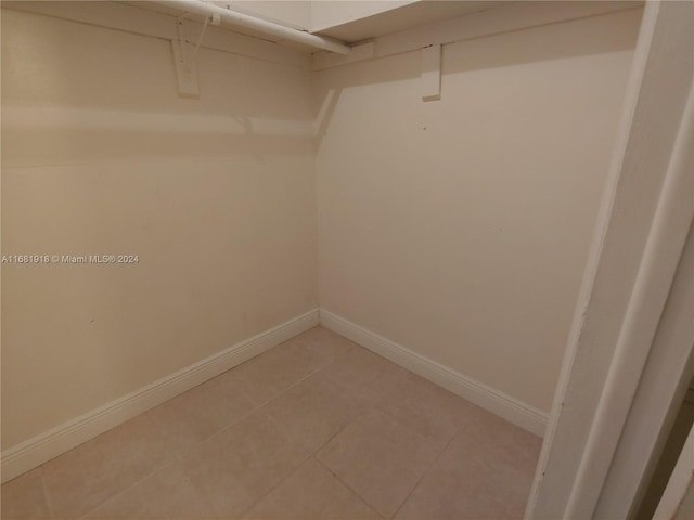 spacious closet featuring tile patterned flooring