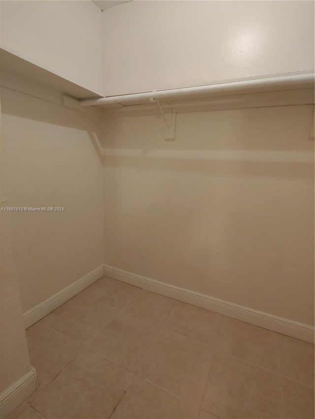 walk in closet with tile patterned floors