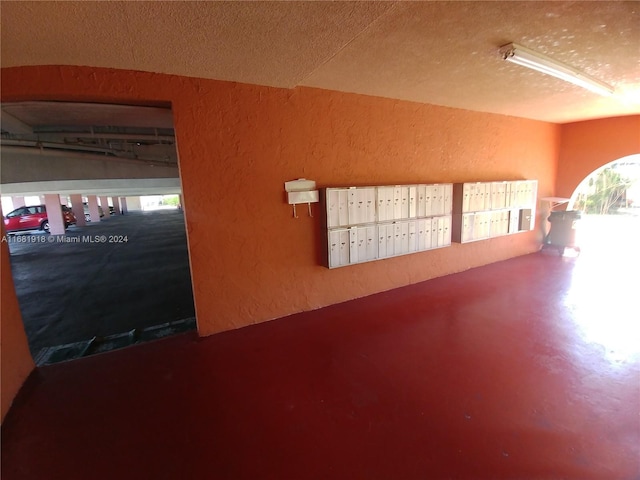 1305 W 53rd St Unit 410, Hialeah, FL 33012 - view of home's community featuring a textured wall, mail area, and a textured ceiling