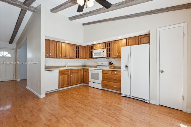 kitchen with backsplash, beamed ceiling, sink, and white appliances