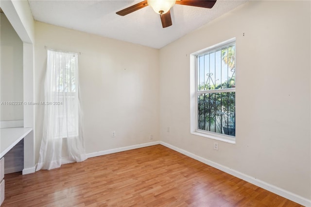 unfurnished room featuring light hardwood / wood-style floors, a textured ceiling, and ceiling fan