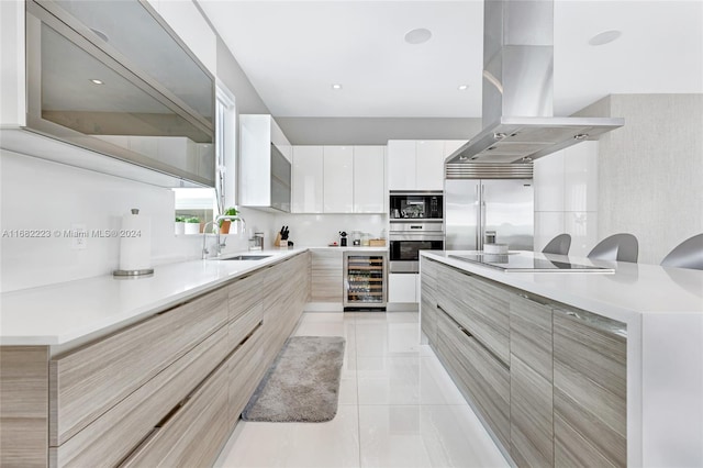 kitchen featuring white cabinets, beverage cooler, island range hood, black appliances, and sink