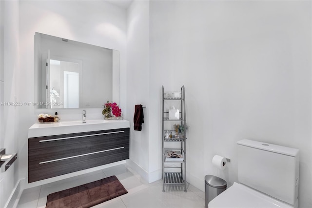 bathroom featuring vanity, toilet, and tile patterned flooring