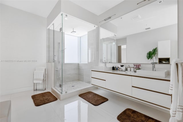 bathroom featuring vanity, a shower with shower door, and tile patterned floors