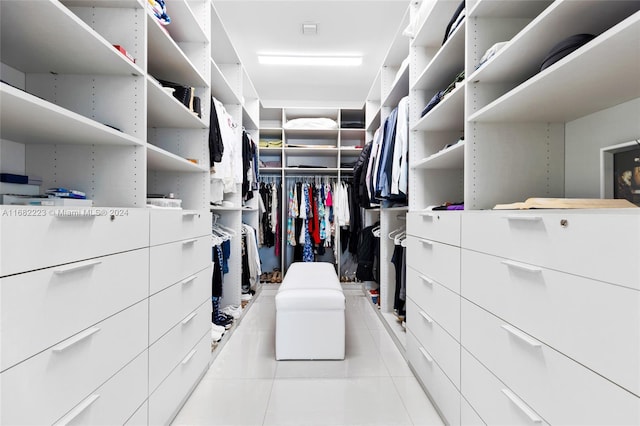 walk in closet with light tile patterned floors