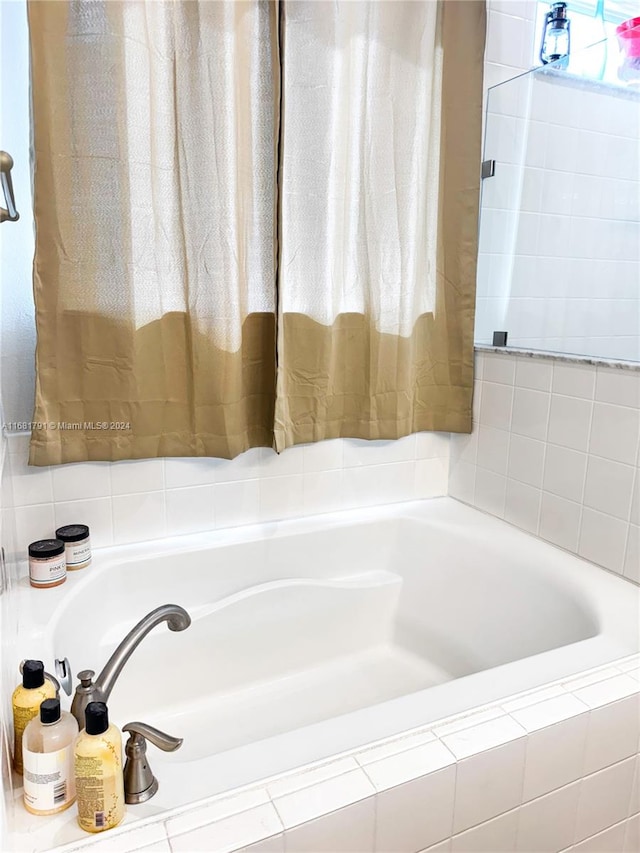 bathroom with tiled bath