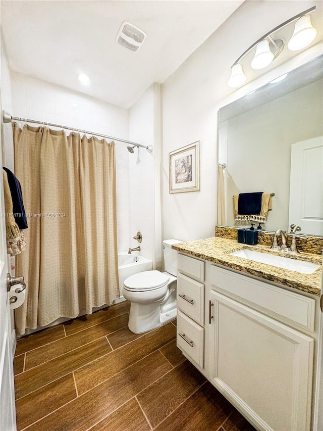 full bathroom with toilet, shower / bath combo with shower curtain, and vanity