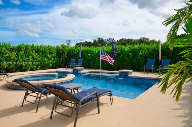 view of pool featuring an in ground hot tub, a patio, and pool water feature