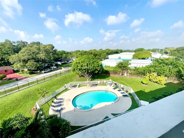 view of pool with a yard