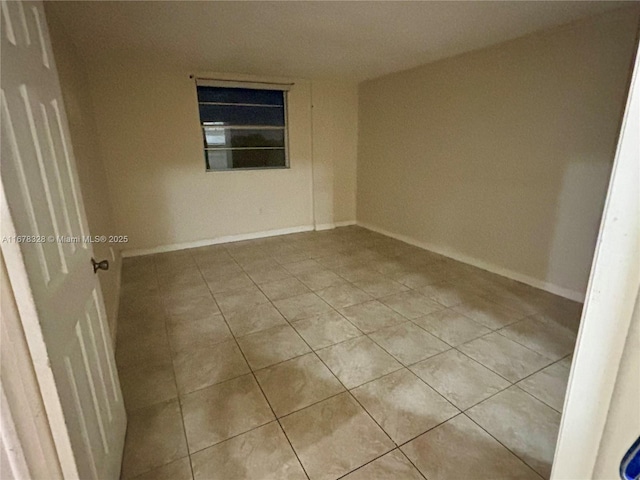 spare room featuring light tile patterned floors