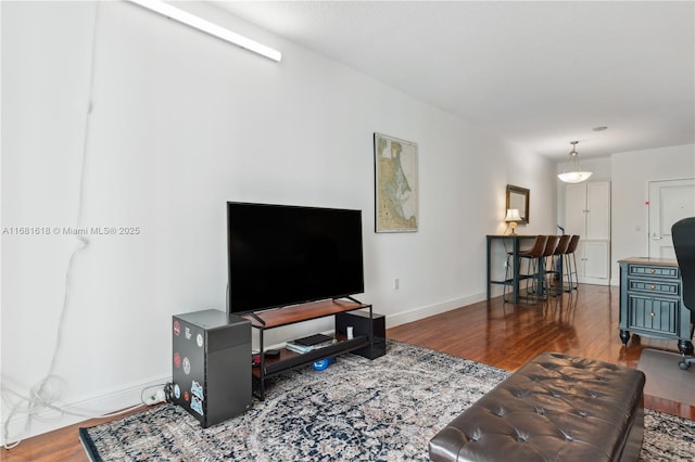 living room featuring dark wood-style floors and baseboards