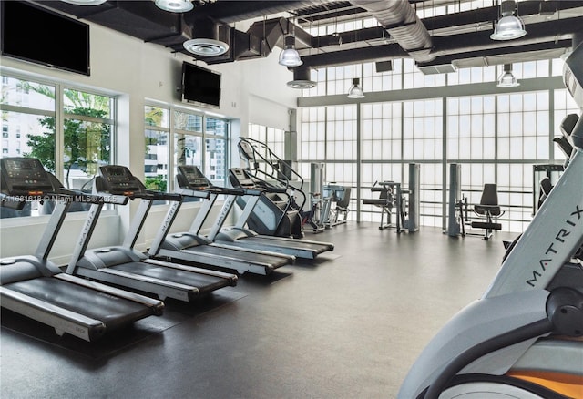 workout area featuring a high ceiling