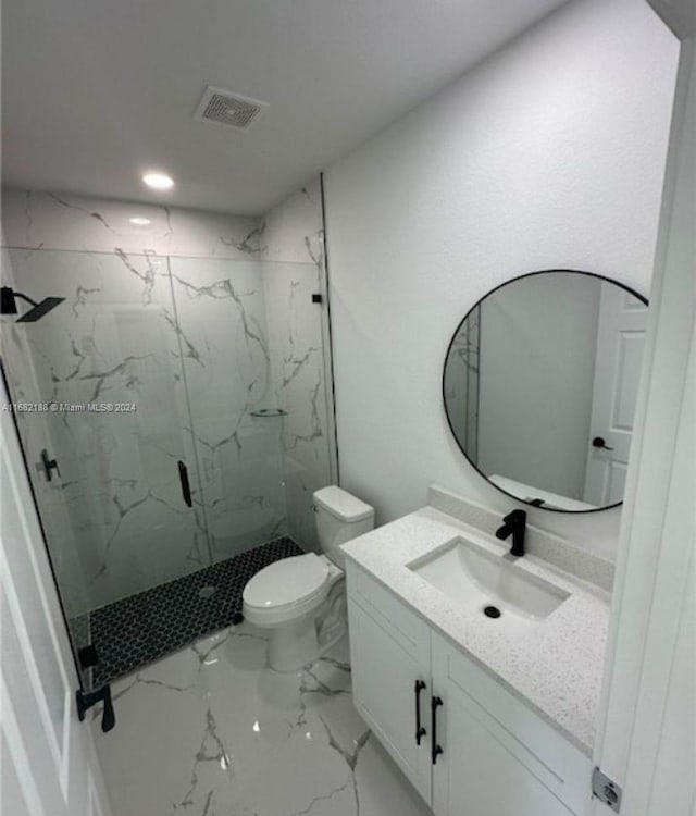 bathroom with a shower with door, toilet, and vanity