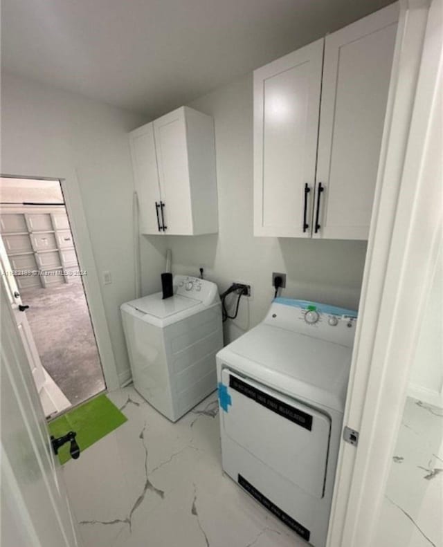 washroom with cabinets, hookup for an electric dryer, and a wealth of natural light