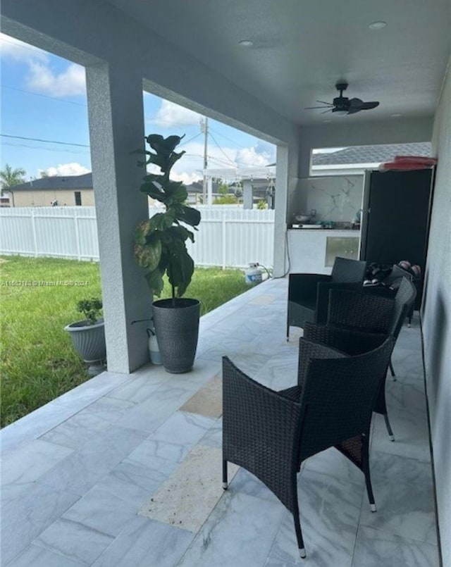 view of patio featuring ceiling fan