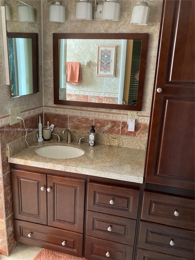 bathroom with vanity and tasteful backsplash