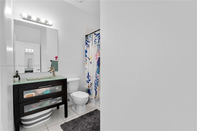 bathroom with tile patterned floors, toilet, curtained shower, and vanity