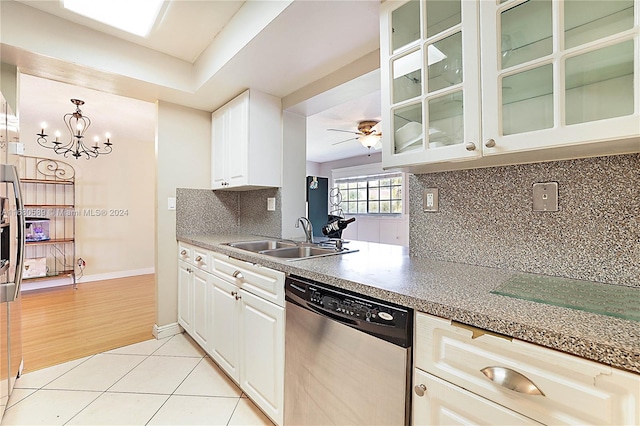 kitchen with sink, light wood-type flooring, stainless steel dishwasher, white cabinetry, and tasteful backsplash