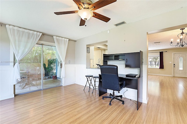 office area with a healthy amount of sunlight, a textured ceiling, and hardwood / wood-style floors