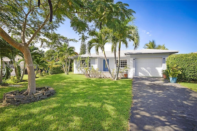 ranch-style home with a front yard and a garage