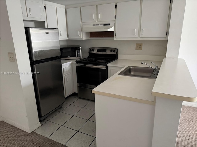 kitchen featuring light tile patterned floors, stainless steel appliances, white cabinets, and sink