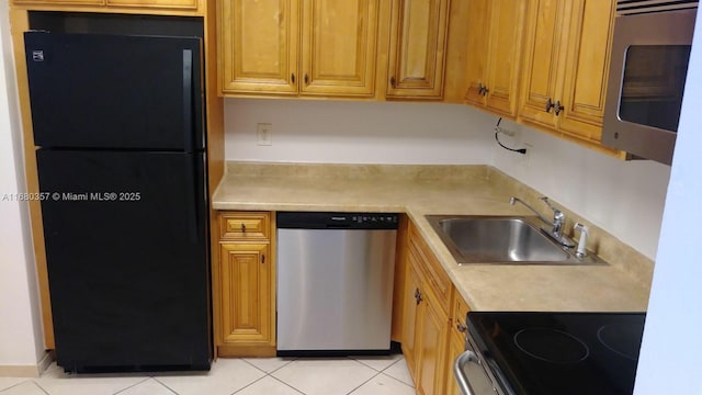 kitchen with sink, light tile patterned flooring, and appliances with stainless steel finishes