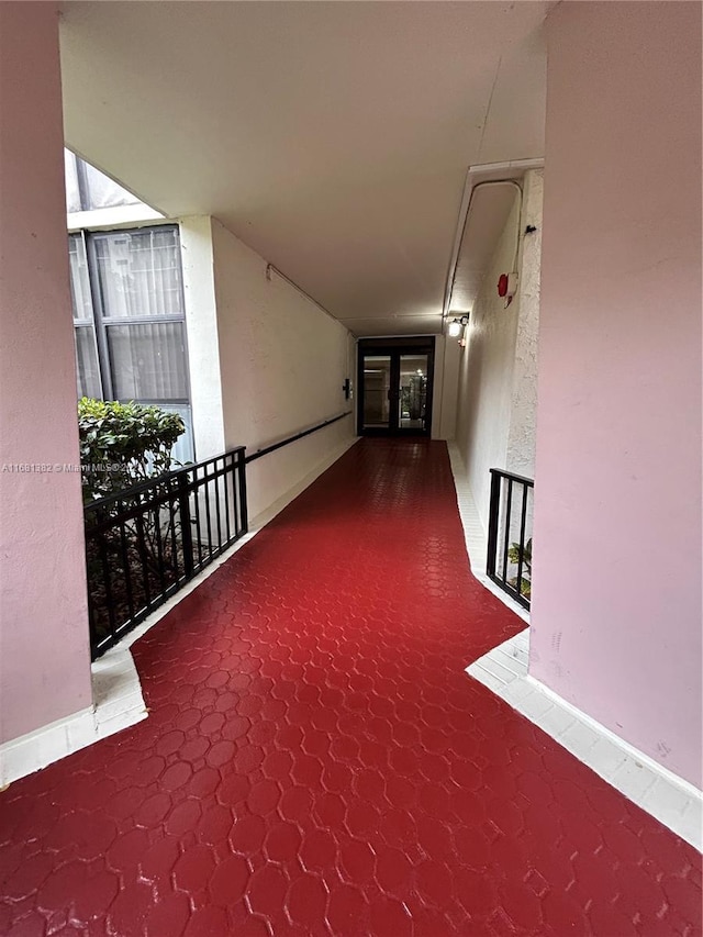 hallway with carpet flooring and french doors