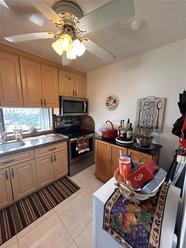 kitchen featuring ceiling fan, light tile patterned flooring, sink, and stainless steel appliances