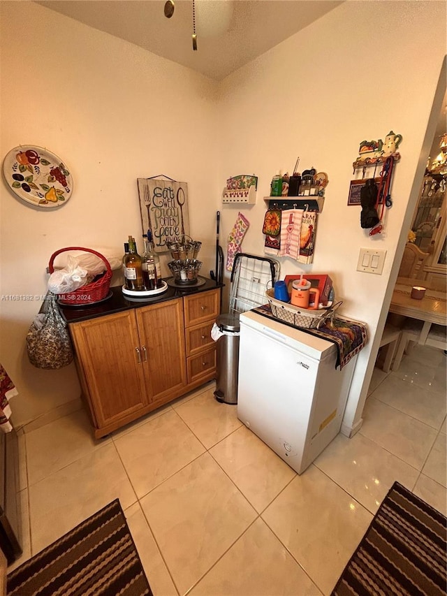 kitchen with light tile patterned floors and fridge