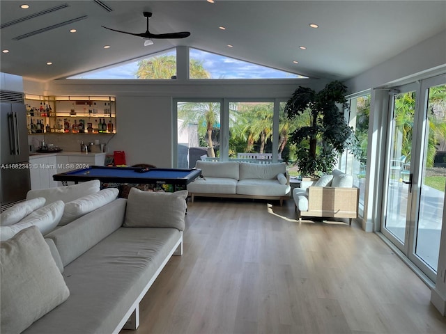 playroom featuring wood-type flooring, vaulted ceiling, pool table, and bar area