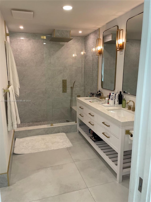 bathroom featuring vanity, tile patterned floors, and tiled shower