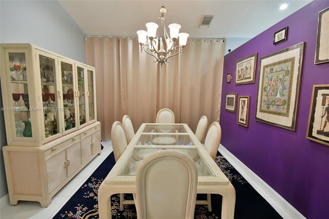 tiled dining area featuring a chandelier